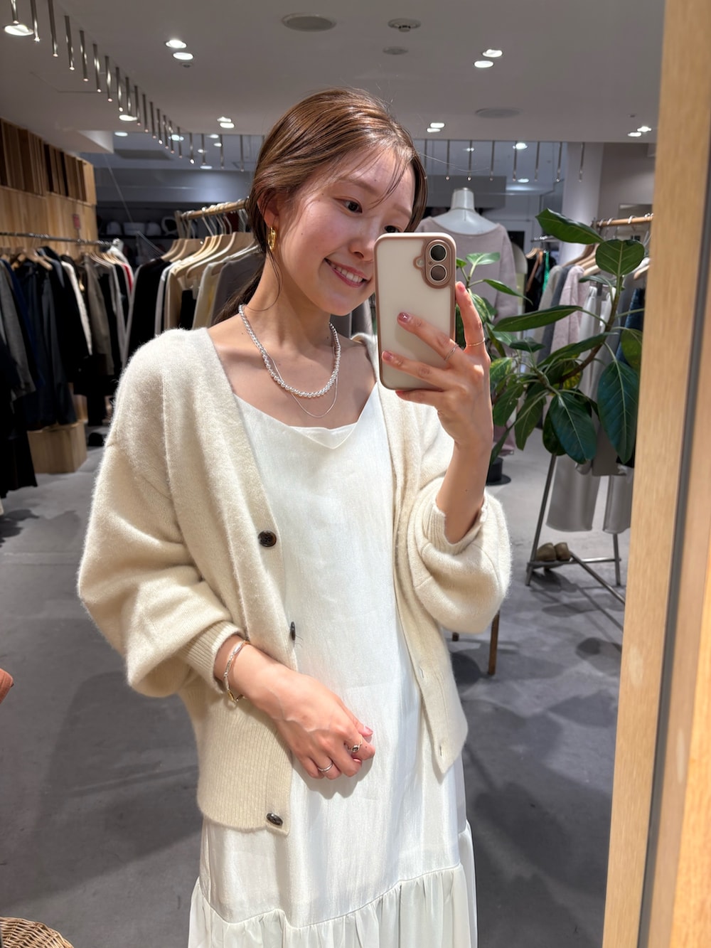 ホワイト系のカーディガン/ボレロ、ホワイト系のワンピース、ホワイト系のキャミソールを着用したレディースの秋コーディネートの2枚目の写真