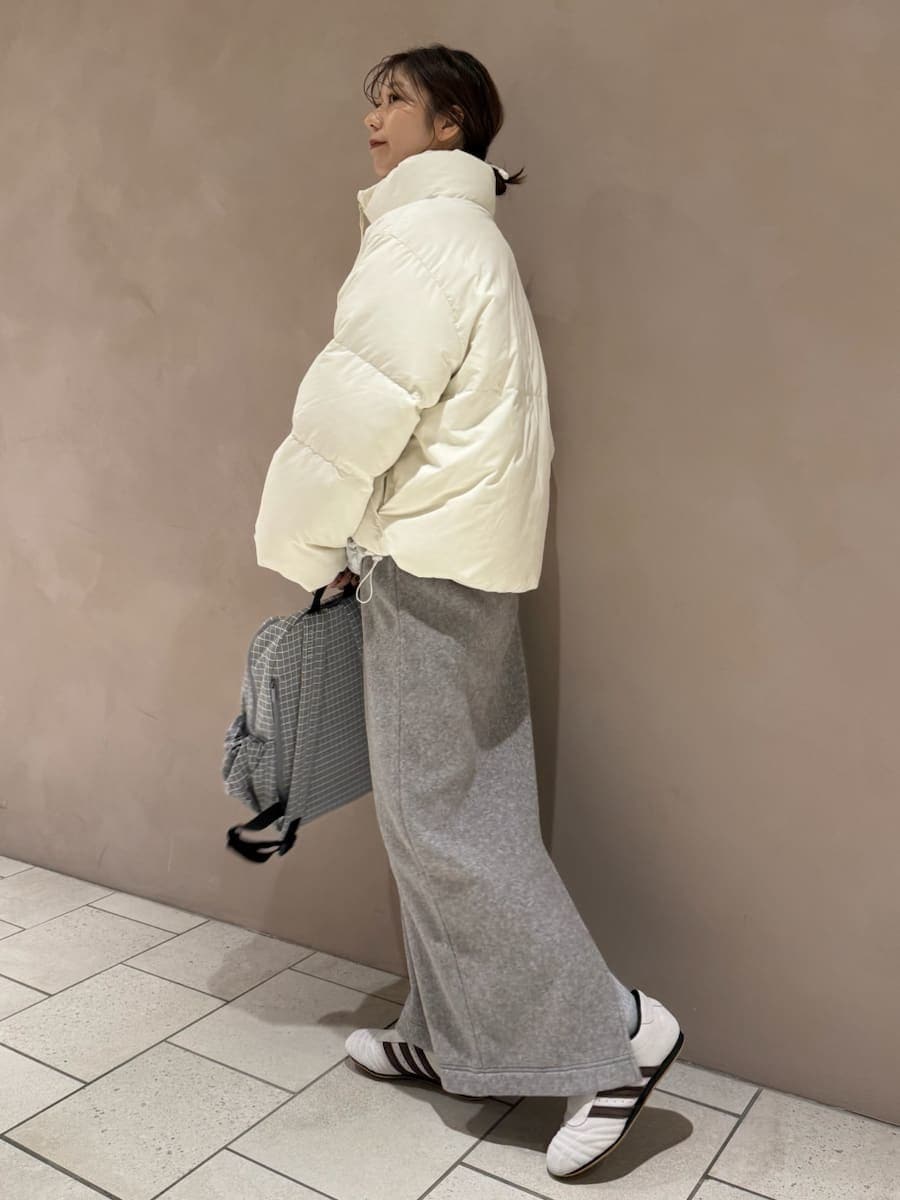グレー系のワンピース、ホワイト系のダウンジャケット/コート、グレー系のバックパック/リュックを着用したレディースの秋コーディネートの3枚目の写真