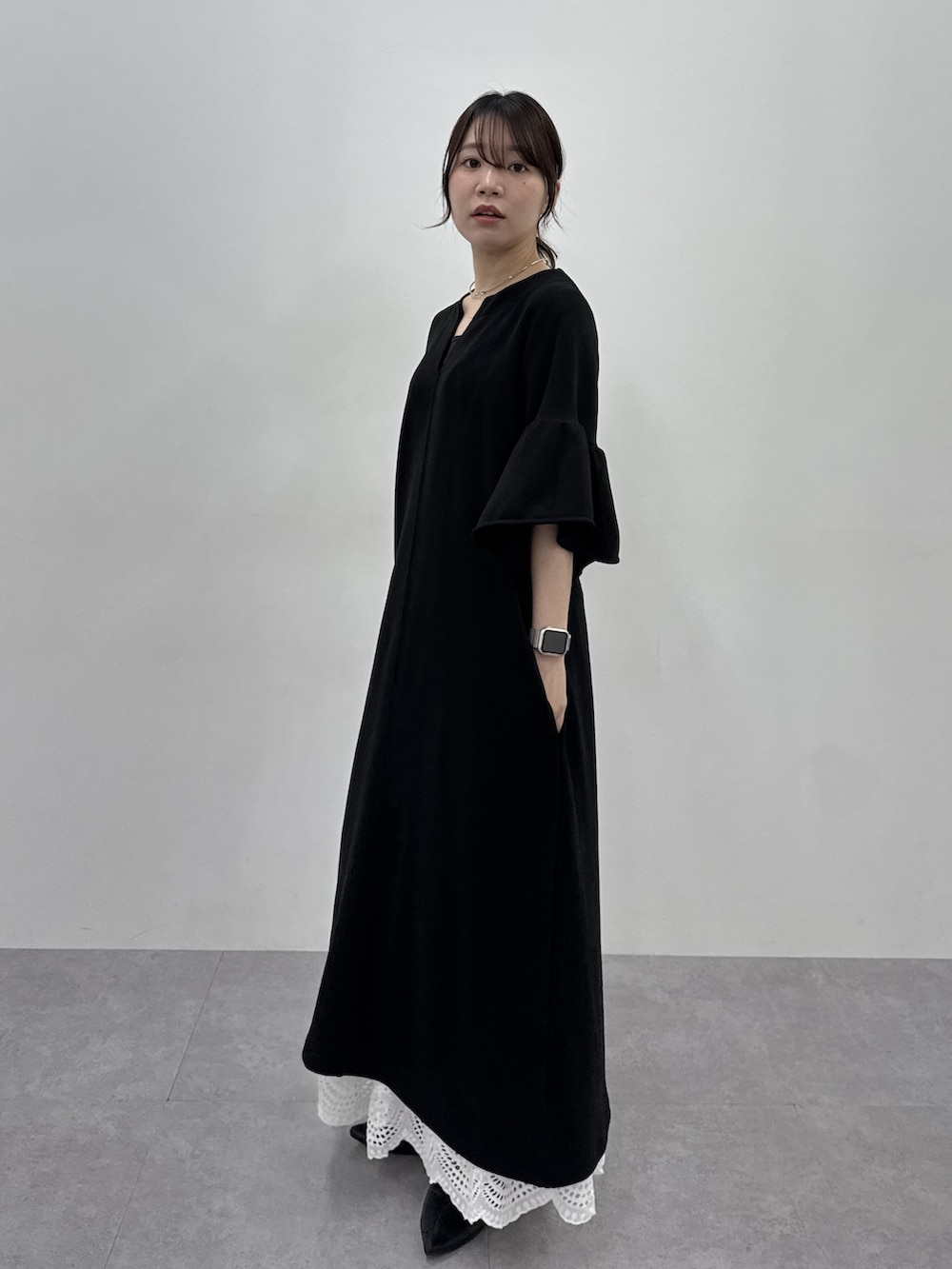 ブラック系のワンピースを着用したレディースの春コーディネートの2枚目の写真