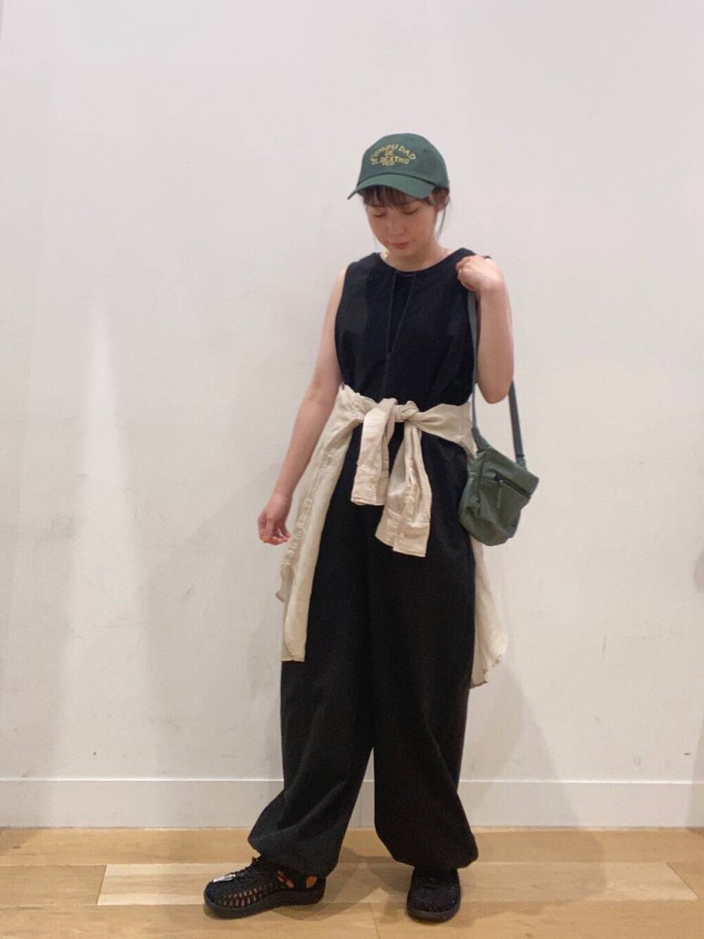 ブラック系のワンピース、ブラック系のタンクトップ、グリーン系のショルダーバッグを着用したレディースの夏コーディネートの5枚目の写真