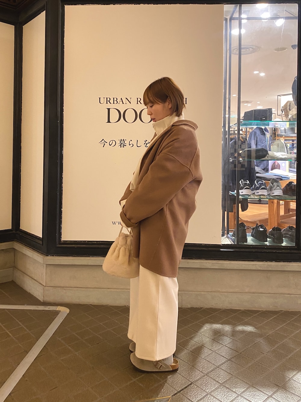 ホワイト系のTシャツ/カットソー、ホワイト系のスカート、ホワイト系のショルダーバッグを着用したレディースの秋コーディネートの3枚目の写真