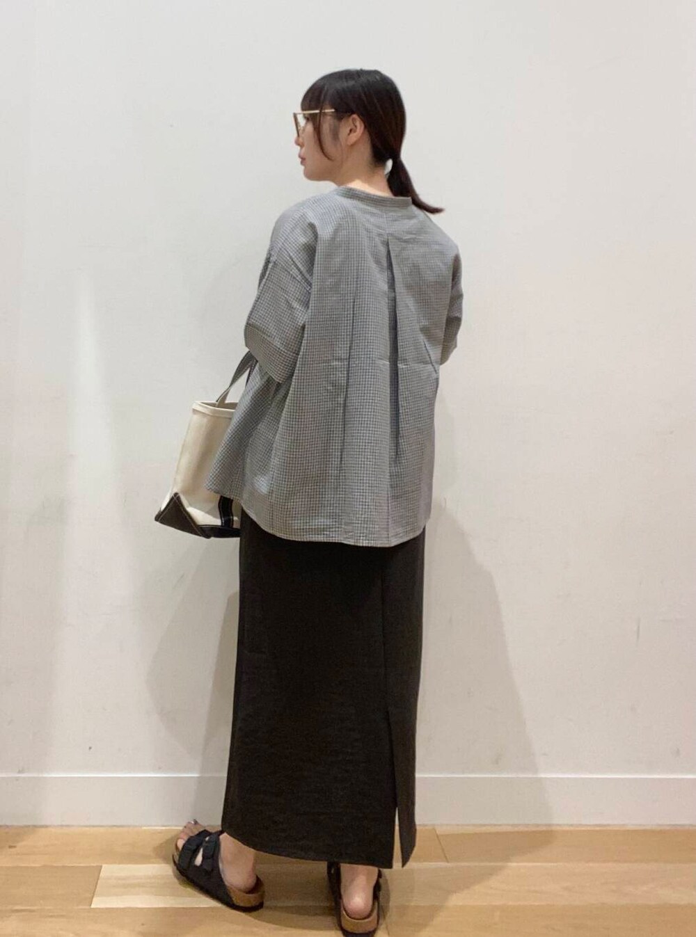 ベージュ系のタンクトップ、グレー系のサンダル、グレー系のワンピースを着用したレディースの夏コーディネートの2枚目の写真