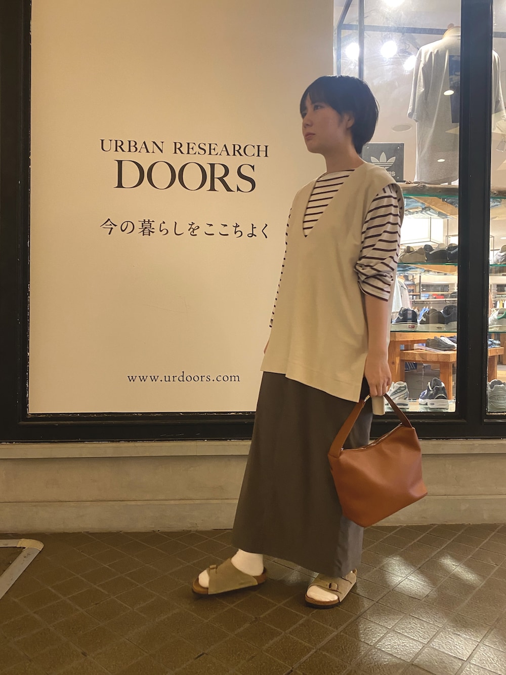 ホワイト系のベスト、レッド系のTシャツ/カットソー、イエロー系のショルダーバッグを着用したレディースの夏コーディネートの2枚目の写真