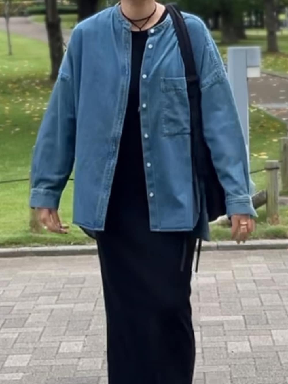 ブルー系のシャツ/ブラウス、ブラック系のワンピース、ブラック系のブーツを着用したレディースの秋コーディネートの4枚目の写真