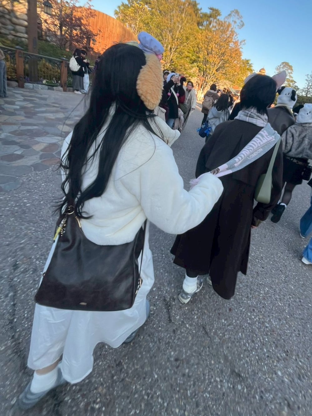 ホワイト系のカーディガン/ボレロ、グレー系のスニーカー、ホワイト系のワンピースを着用したレディースの冬コーディネートの3枚目の写真