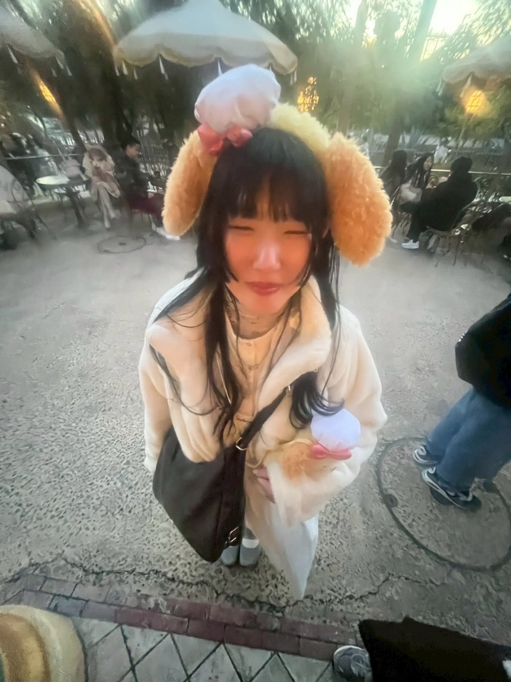 ホワイト系のカーディガン/ボレロ、グレー系のスニーカー、ホワイト系のワンピースを着用したレディースの冬コーディネートの2枚目の写真