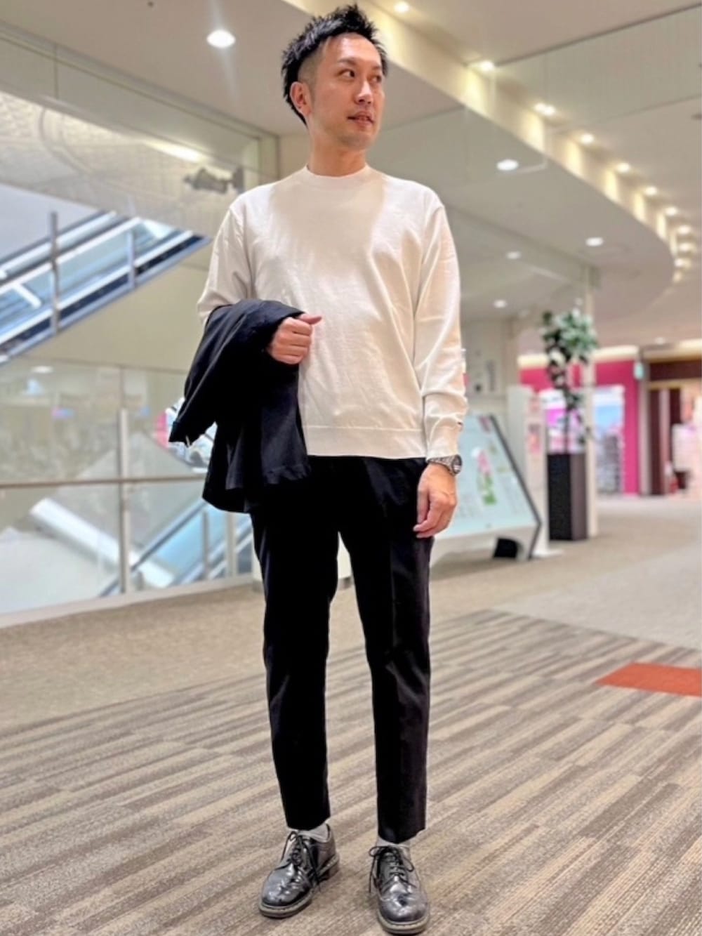 ホワイト系のニット/セーター、ブルー系のテーラードジャケット、ブルー系のスラックスを着用したメンズの春コーディネートの2枚目の写真