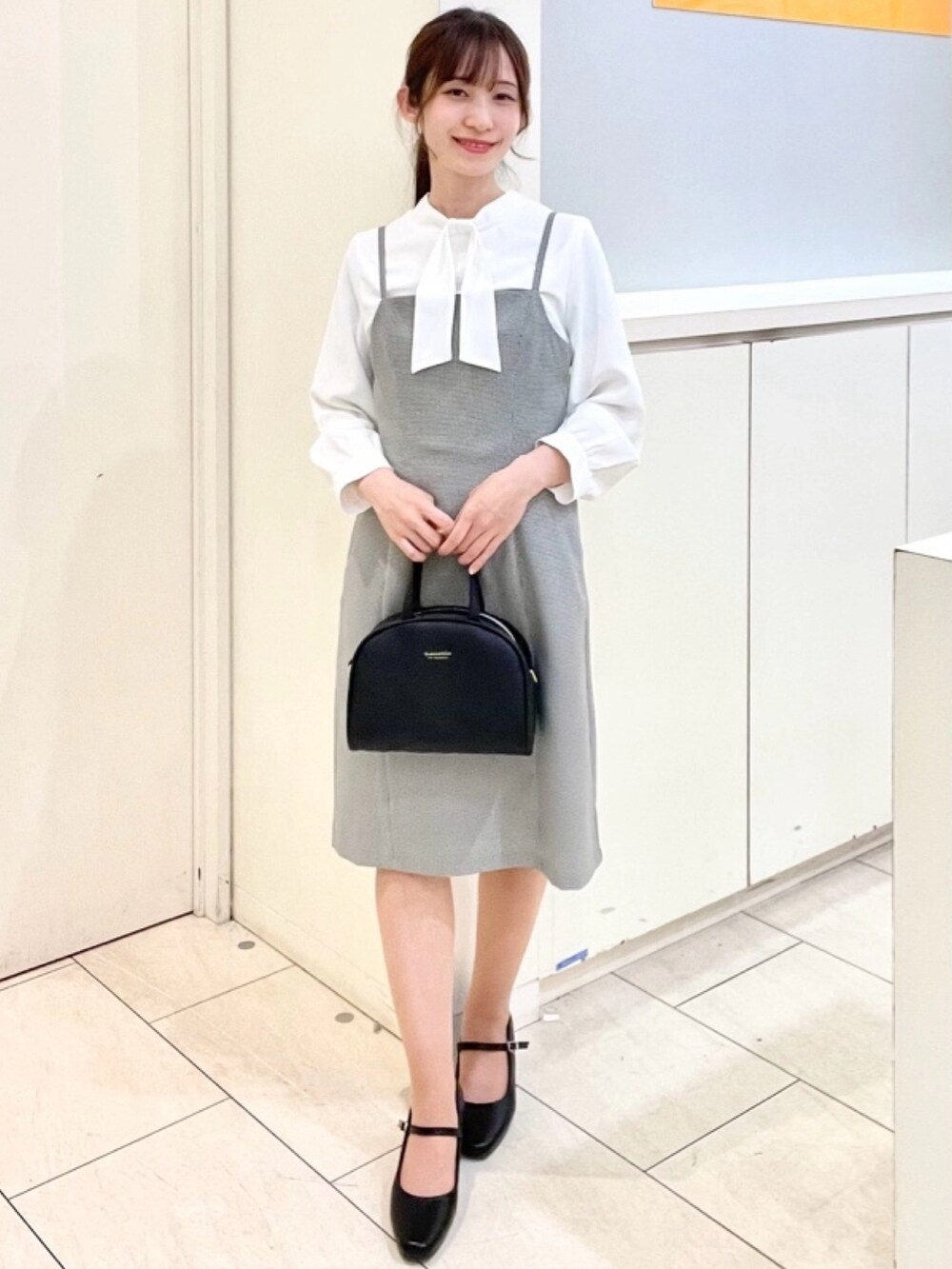 ホワイト系のシャツ/ブラウス、ホワイト系のジャンパースカート、ホワイト系のスーツジャケットを着用したレディースの春コーディネートの2枚目の写真