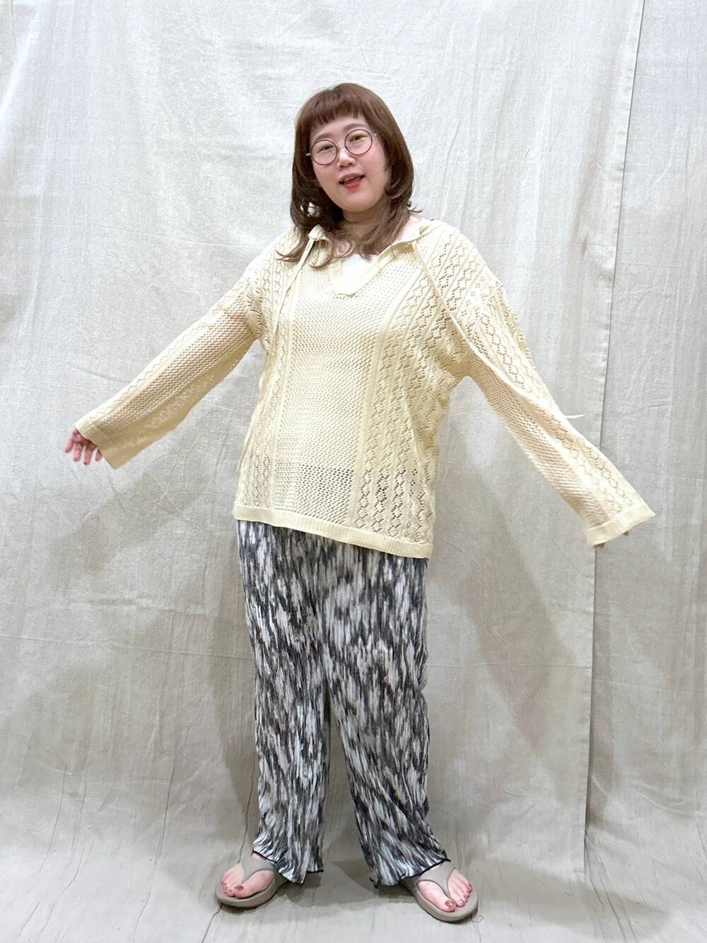 ホワイト系のニット/セーター、ブラック系のその他パンツ、ホワイト系のタンクトップを着用したレディースの夏コーディネートの4枚目の写真