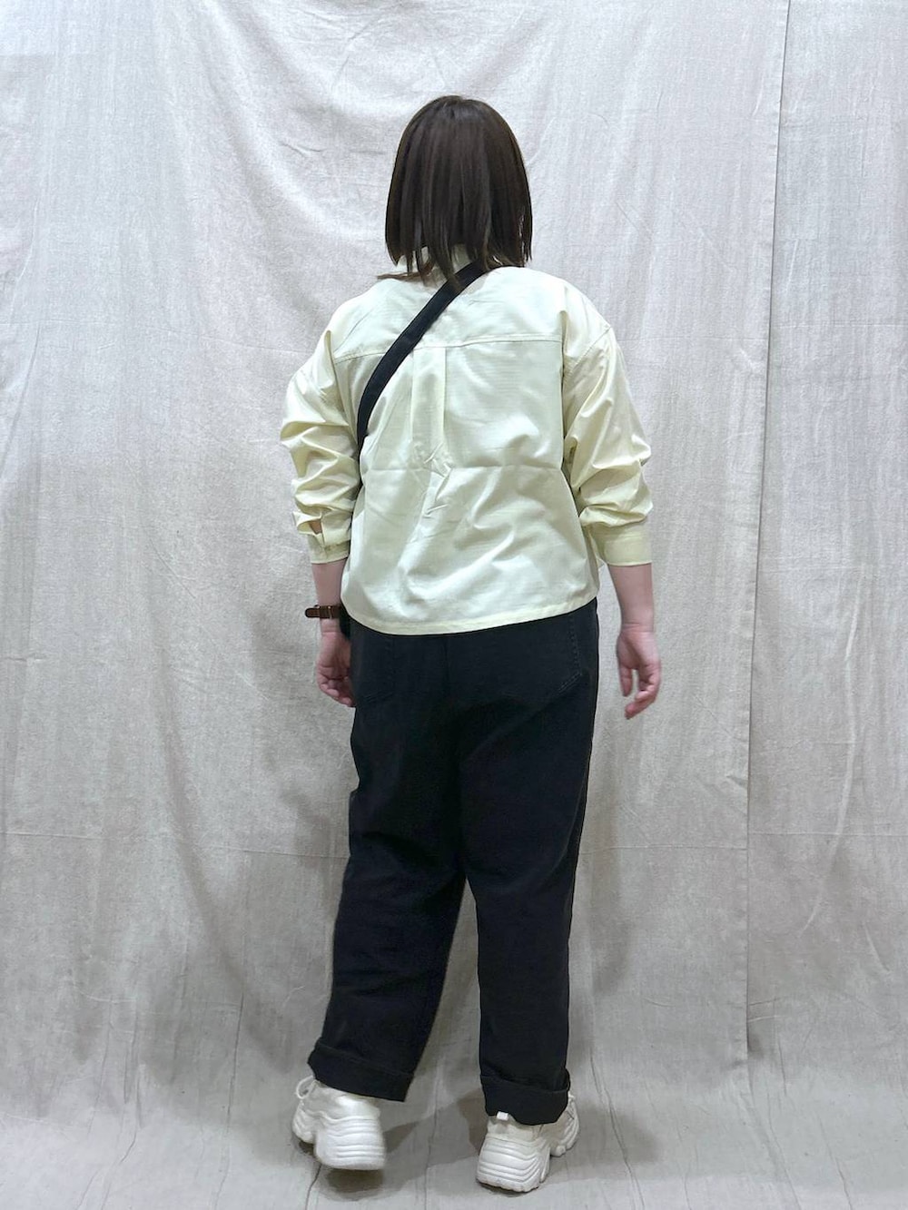 ブラック系のタンクトップ、ブラック系のデニムパンツ、イエロー系のシャツ/ブラウスを着用したレディースの春コーディネートの3枚目の写真