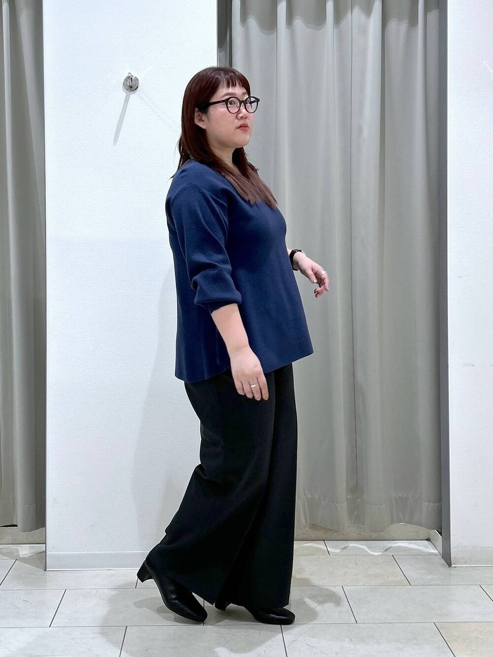 ブルー系のニット/セーター、ブラック系のその他パンツ、ブラック系のブーツを着用したレディースの秋コーディネートの5枚目の写真