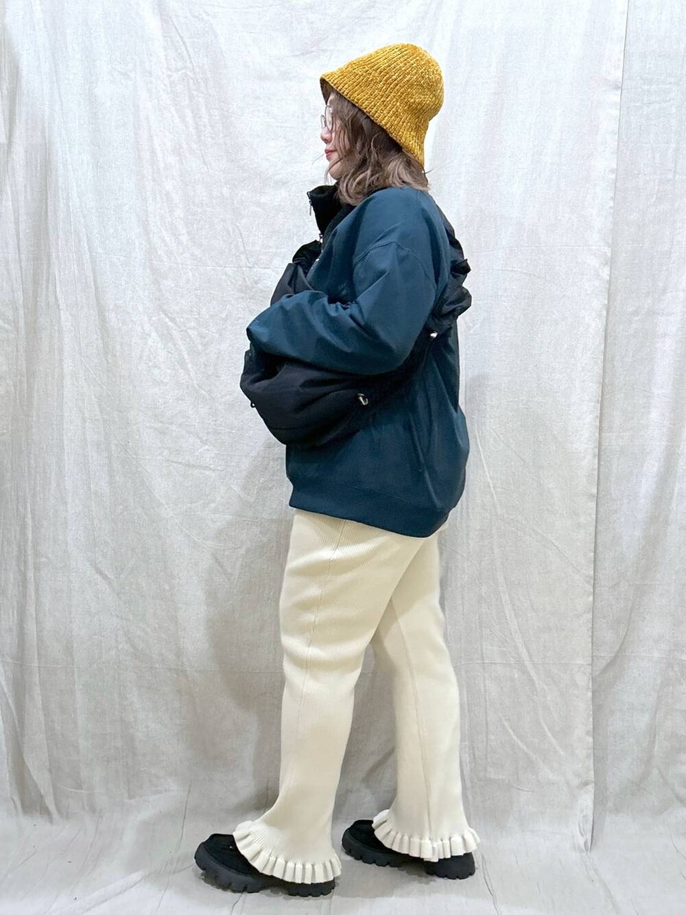 グリーン系のTシャツ/カットソー、ブラック系のモカシン/デッキシューズ、ブラック系のショルダーバッグを着用したレディースの秋コーディネートの5枚目の写真