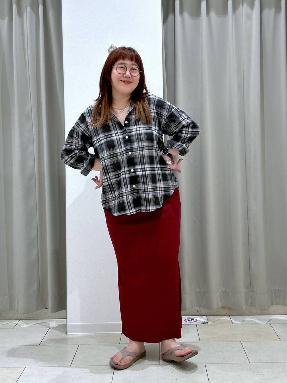 レッド系のスカート、ホワイト系のキャミソール、ベージュ系のサンダルを着用したレディースの夏コーディネートの3枚目の写真