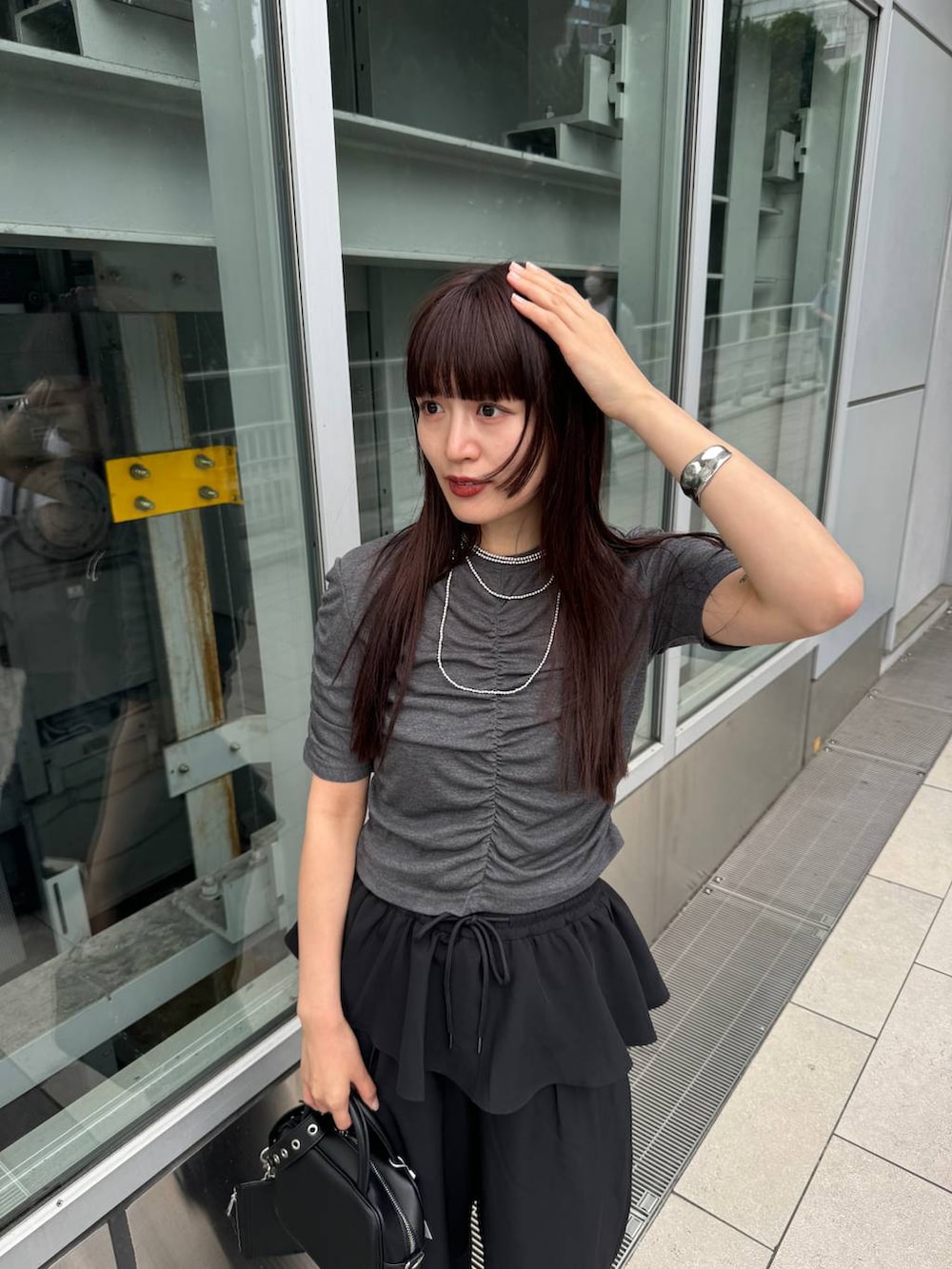 ブラック系のショルダーバッグ、グレー系のTシャツ/カットソー、ブラック系のその他パンツを着用したレディースの夏コーディネートの7枚目の写真