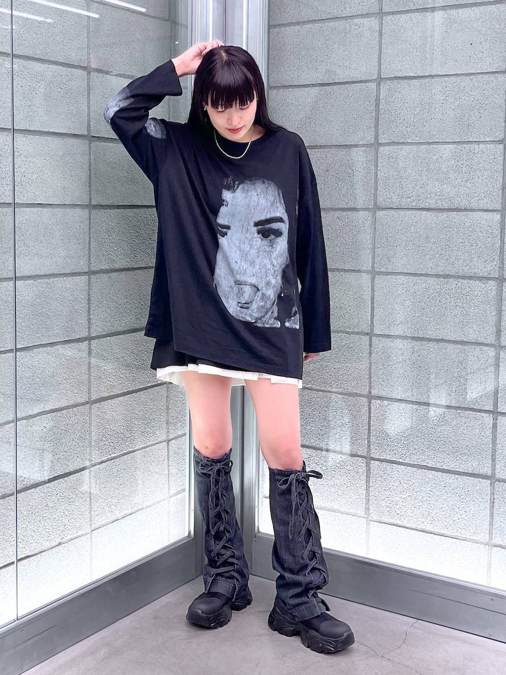 ブラック系のブーツ、ブラック系のスカート、ブラック系のTシャツ/カットソーを着用したレディースの夏コーディネートの3枚目の写真