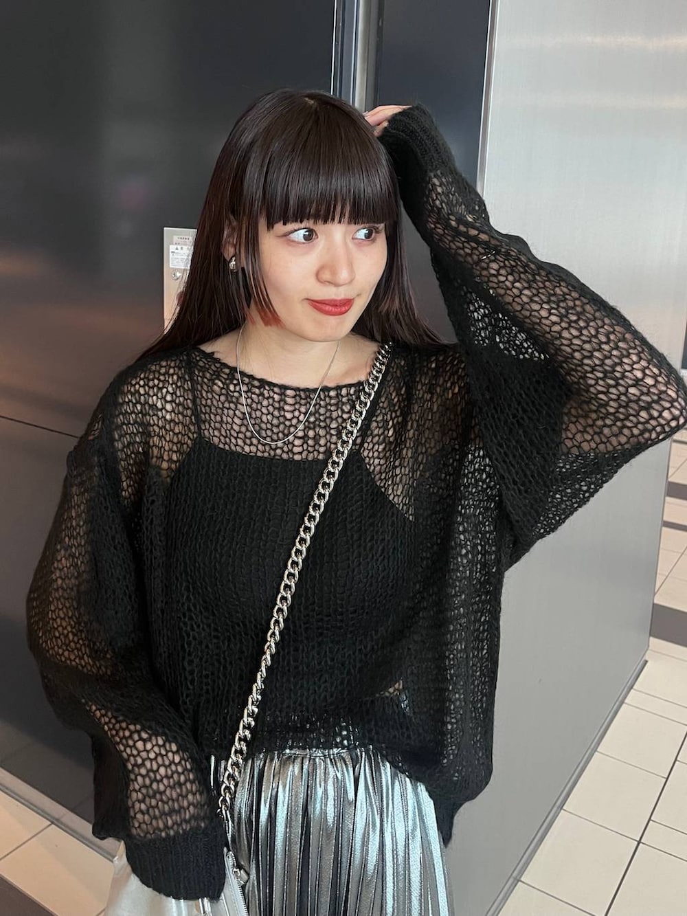 シルバー系のスカート、ブラック系のニット/セーターを着用したレディースの秋コーディネートの5枚目の写真