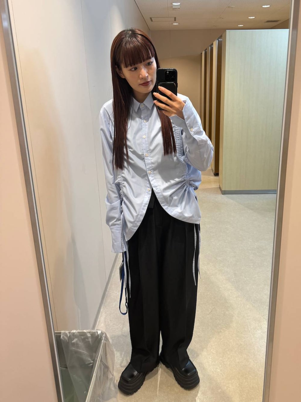 ブルー系のシャツ/ブラウス、ブラック系のスラックスを着用したレディースの秋コーディネートの2枚目の写真