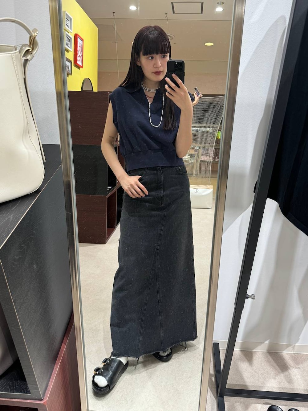 ブルー系のデニムスカート、ブラック系のサンダル、ブルー系のTシャツ/カットソーを着用したレディースの春コーディネートの5枚目の写真