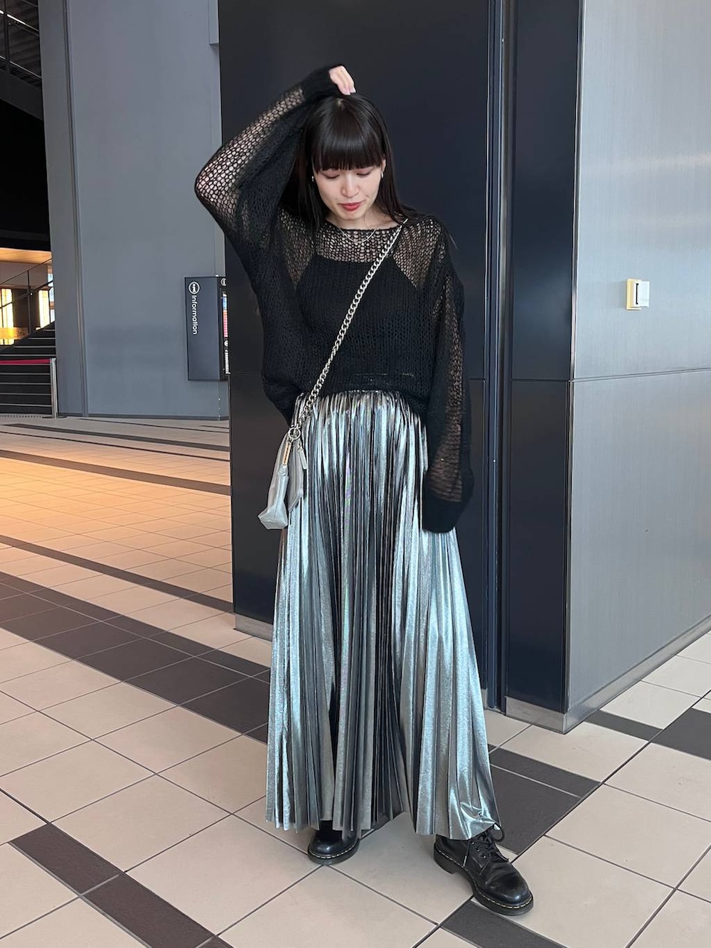 シルバー系のスカート、ブラック系のニット/セーターを着用したレディースの秋コーディネートの3枚目の写真