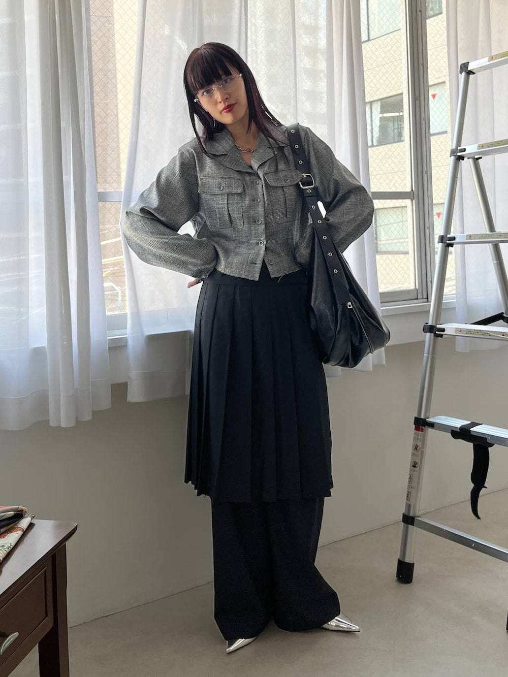 ブラック系のスラックス、ブラック系のショルダーバッグ、グレー系のシャツ/ブラウスを着用したレディースの夏コーディネートの3枚目の写真