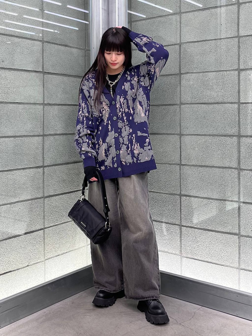 ブルー系のカーディガン/ボレロ、ブラック系のデニムパンツ、ブラック系のショルダーバッグを着用したレディースの冬コーディネートの6枚目の写真