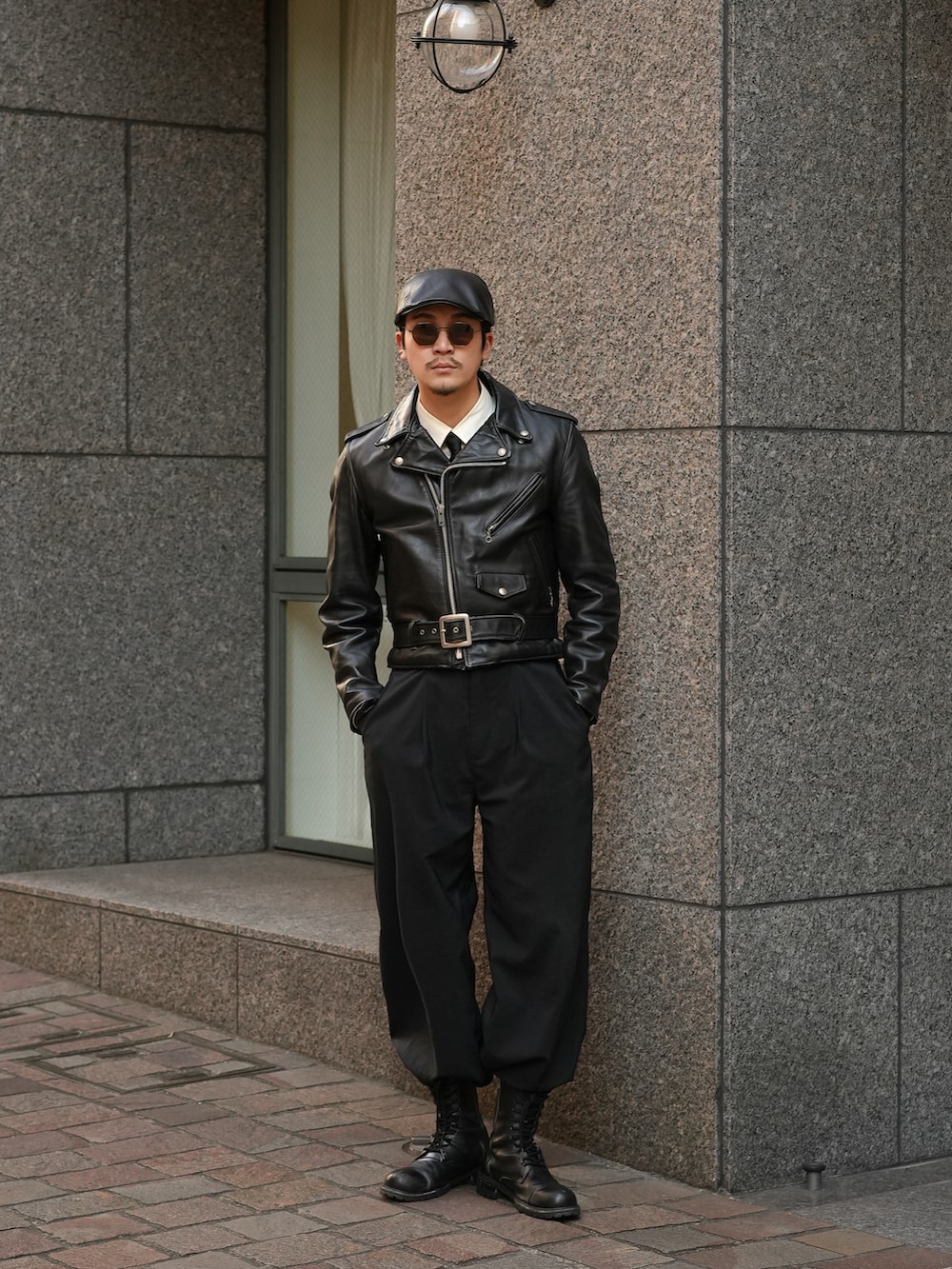 ブラック系のスラックス、ブラック系のブーツ、ブラック系のライダースジャケットを着用したメンズの冬コーディネートの3枚目の写真