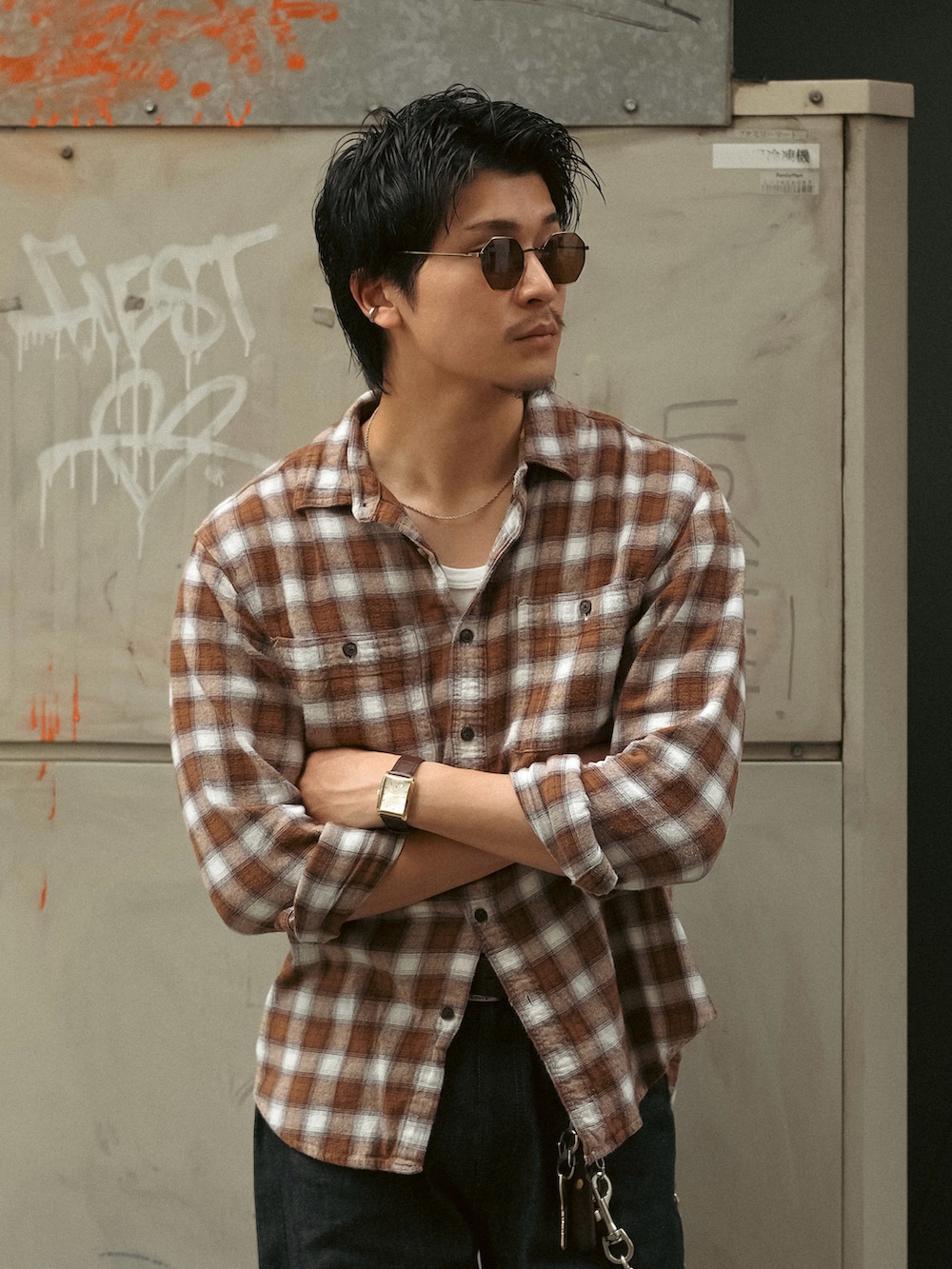 ホワイト系のタンクトップ、ブラック系のデニムパンツ、ブラウン系のブーツを着用したメンズの秋コーディネートの2枚目の写真