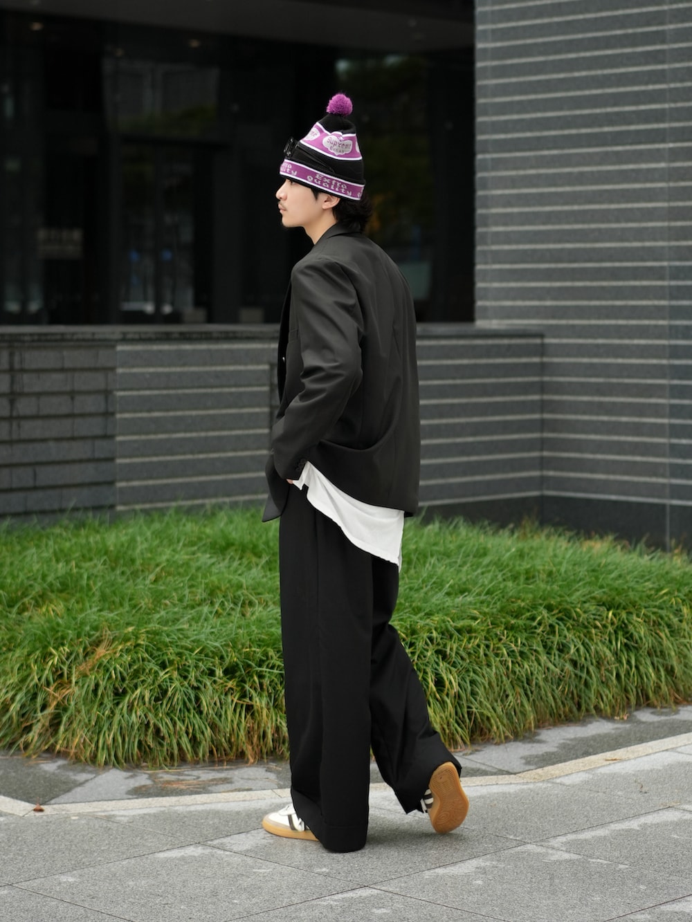 ブラック系のテーラードジャケット、ホワイト系のタンクトップ、ブラック系のその他パンツを着用したメンズの秋コーディネートの3枚目の写真