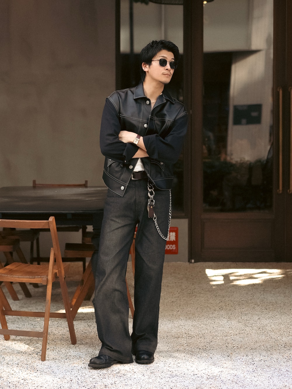 ブラック系のデニムパンツ、ブラック系のブルゾン、ホワイト系のタンクトップを着用したメンズの秋コーディネートの3枚目の写真