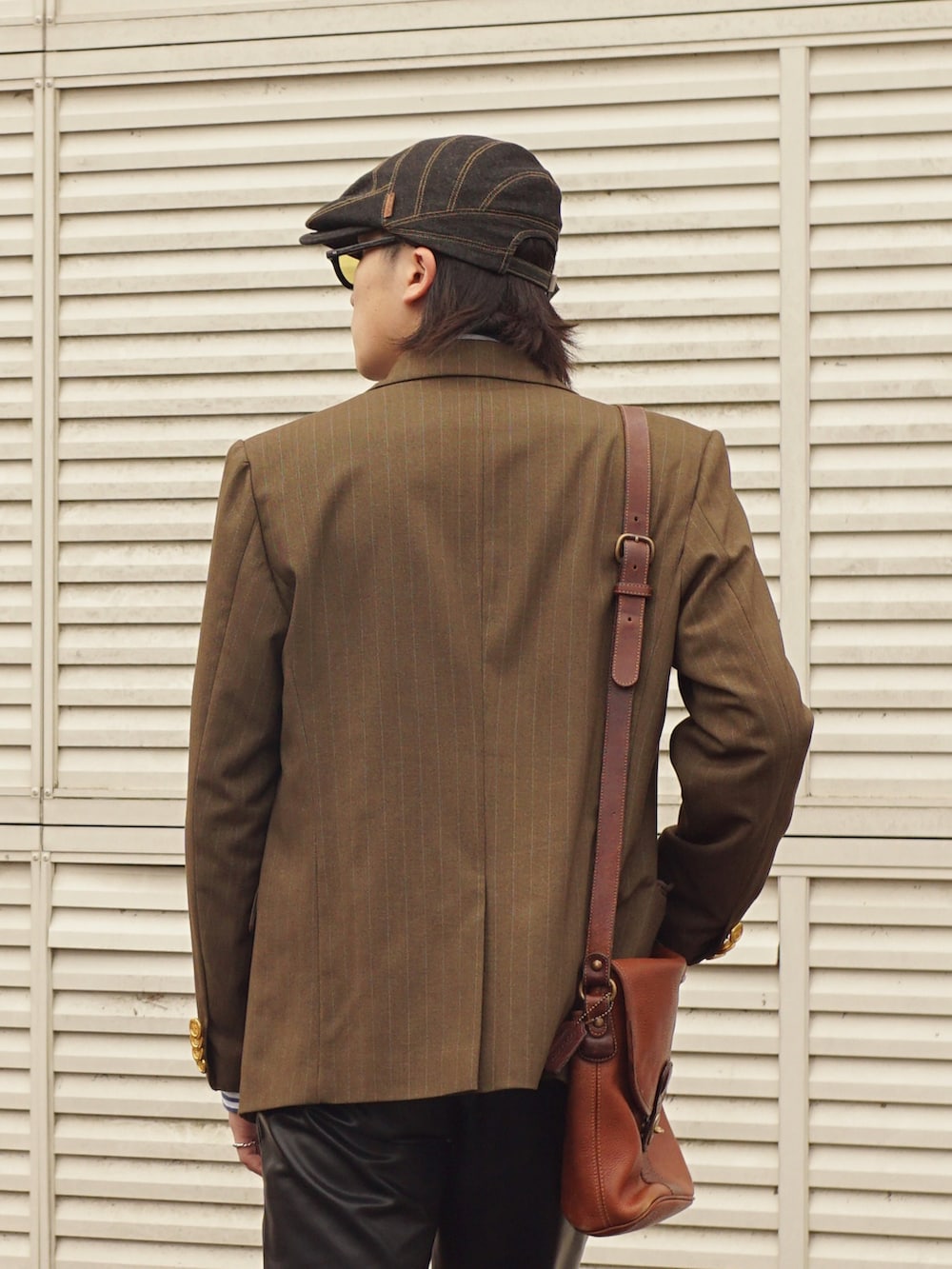 ブラック系のその他パンツ、ブラック系のシューズ、グリーン系のテーラードジャケットを着用したメンズの春コーディネートの5枚目の写真