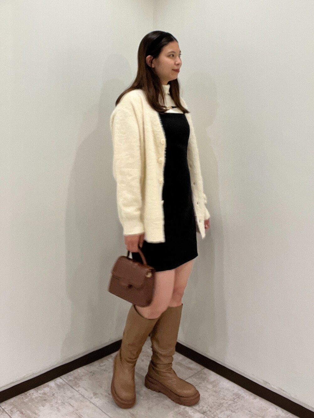 ホワイト系のニット/セーター、ブラック系のワンピース、ホワイト系のカーディガン/ボレロを着用したレディースの秋コーディネートの3枚目の写真