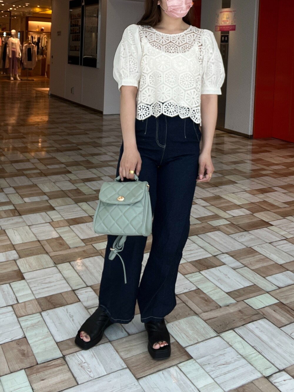 ホワイト系のキャミソール、ホワイト系のシャツ/ブラウス、ブルー系のデニムパンツを着用したレディースの春コーディネートの2枚目の写真