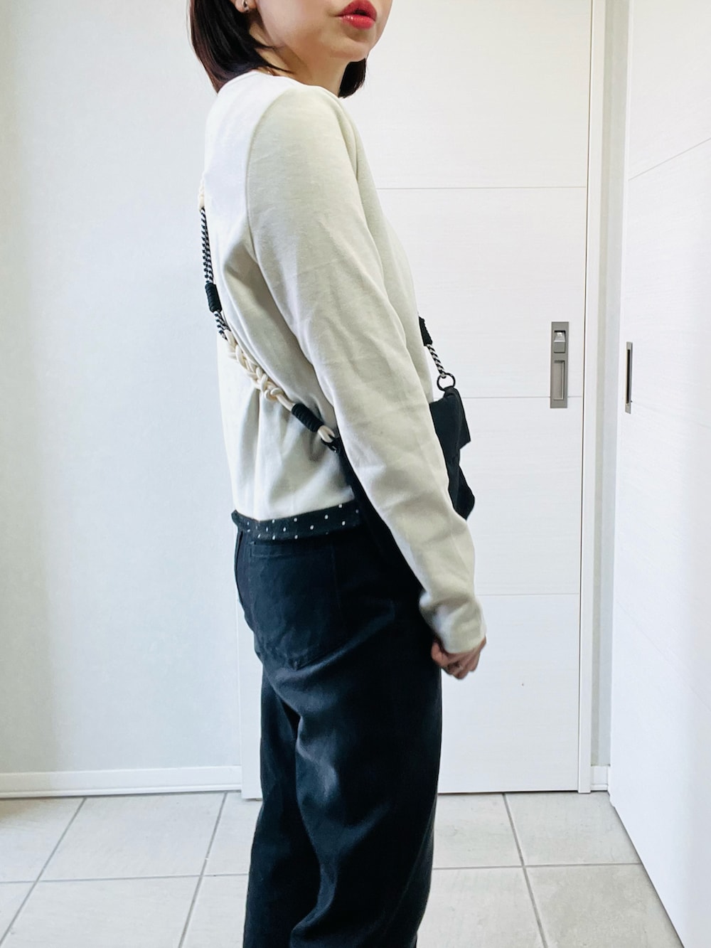 ホワイト系のTシャツ/カットソー、ブラック系のデニムパンツ、ブラック系のショルダーバッグを着用したレディースの春コーディネートの3枚目の写真