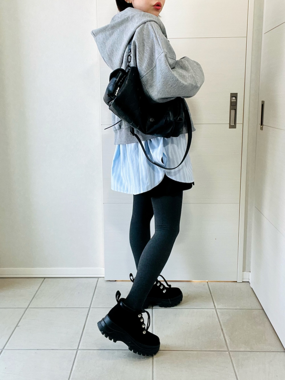 グレー系のパーカー、ブルー系のシャツ/ブラウス、ブラック系のその他パンツを着用したレディースの春コーディネートの5枚目の写真