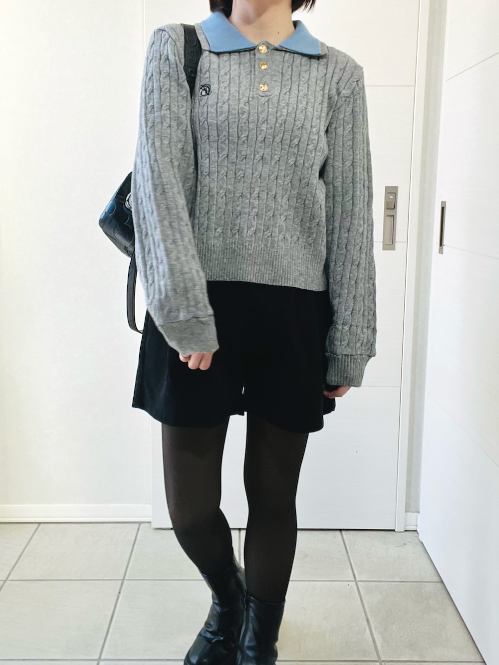 グレー系のニット/セーター、ブラック系のその他パンツ、ブラック系のブーツを着用したレディースの冬コーディネートの2枚目の写真