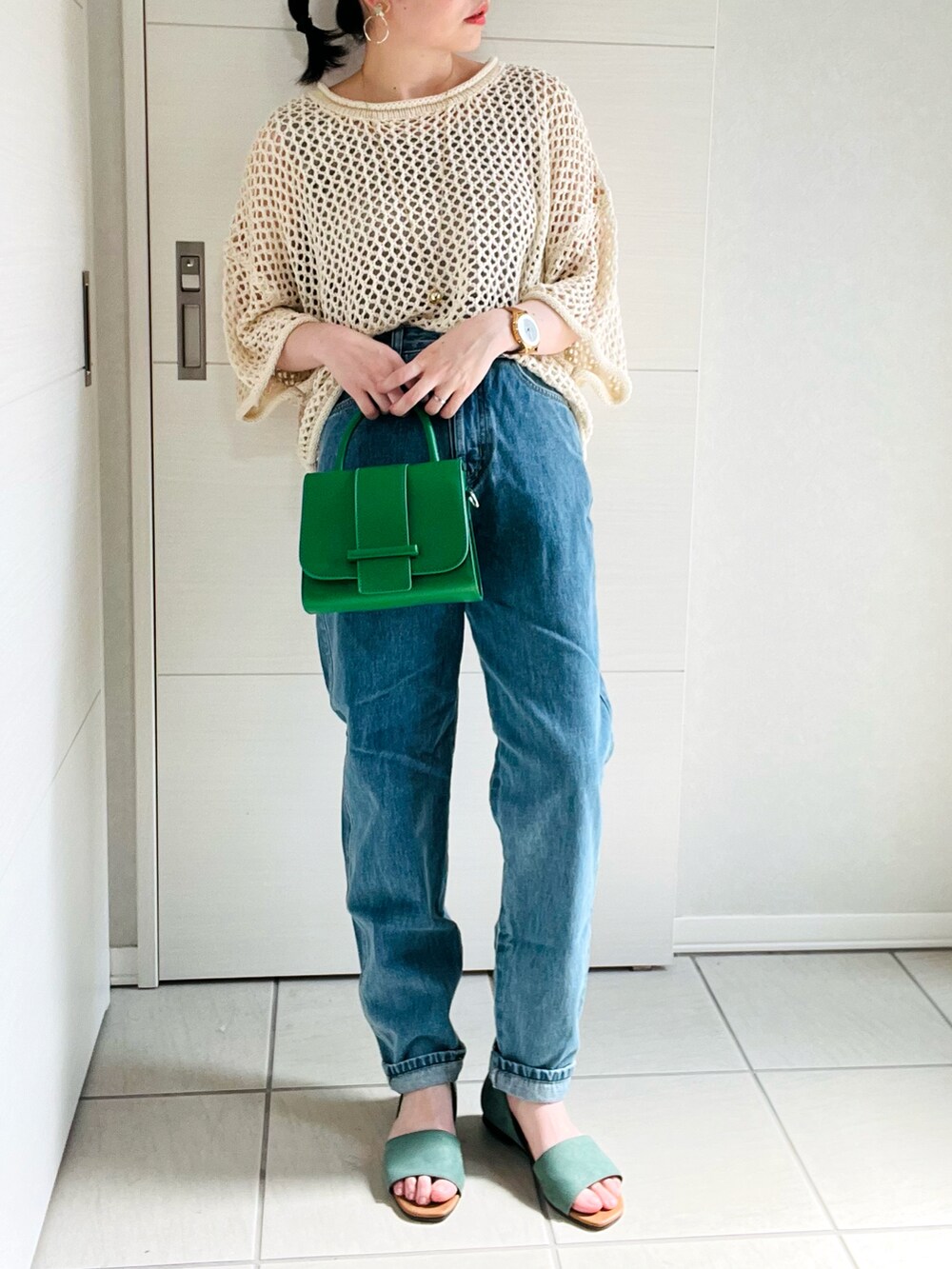ホワイト系のニット/セーター、ブルー系のデニムパンツ、グリーン系のサンダルを着用したレディースの夏コーディネートの4枚目の写真