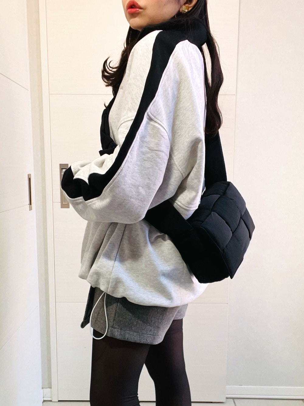 グレー系のスウェット、ブラック系のニット/セーター、グレー系のその他パンツを着用したレディースの冬コーディネートの3枚目の写真