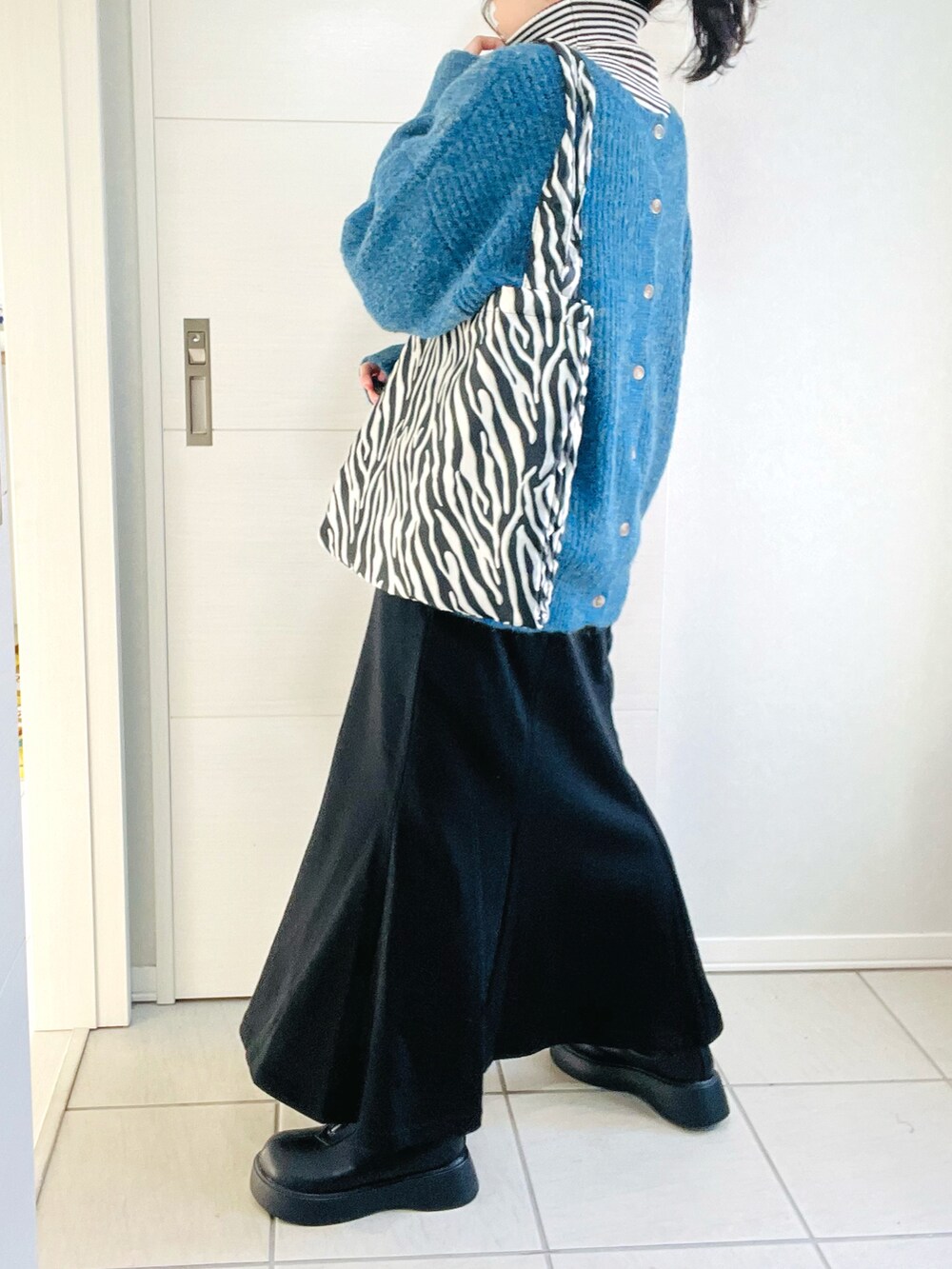 ブルー系のカーディガン/ボレロ、その他のニット/セーター、ブラック系のスカートを着用したレディースの秋コーディネートの5枚目の写真