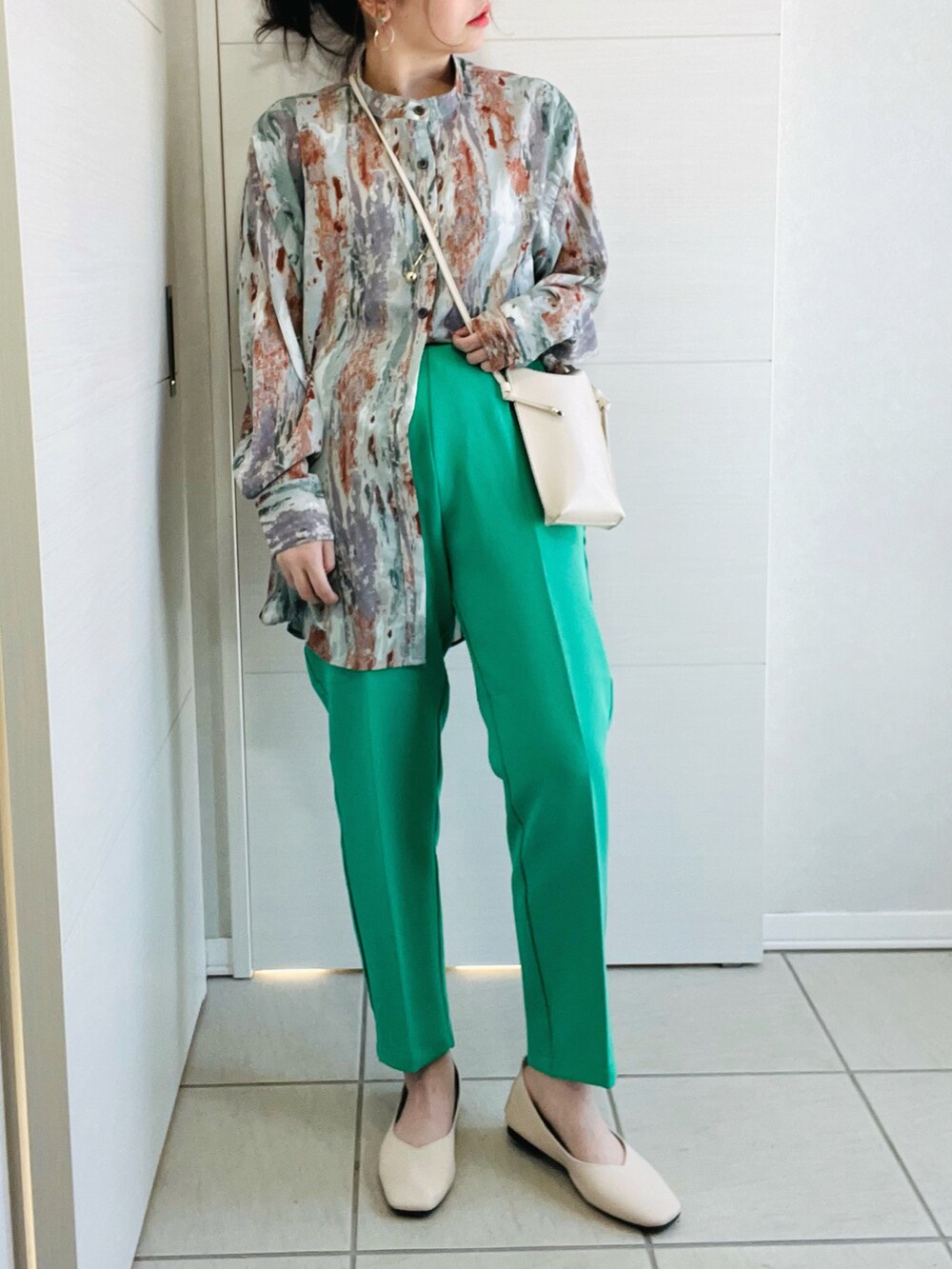 グリーン系のスラックス、グリーン系のシャツ/ブラウス、ホワイト系のバレエシューズを着用したレディースの冬コーディネートの2枚目の写真