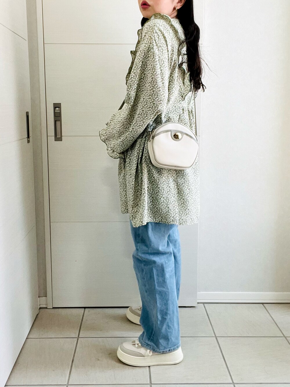 グリーン系のシャツ/ブラウス、ブルー系のデニムパンツ、ホワイト系のスニーカーを着用したレディースの春コーディネートの4枚目の写真