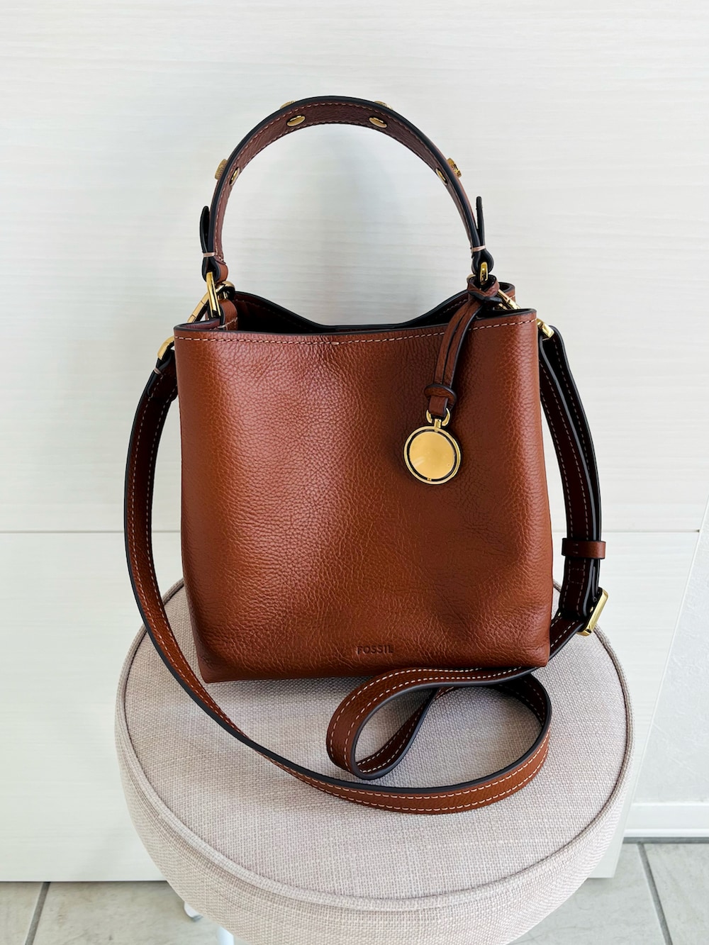 ブラウン系のショルダーバッグ、ベージュ系のニット/セーター、ホワイト系のスカートを着用したレディースの秋コーディネートの3枚目の写真