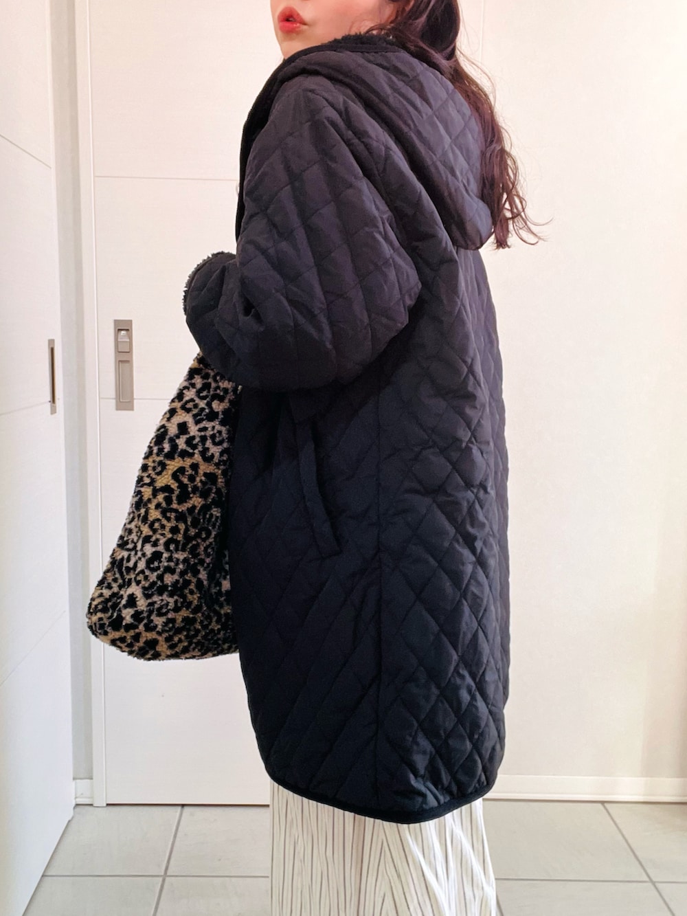 ブラック系のナイロンジャケット、ブルー系のワンピース、ベージュ系のスリッポンを着用したレディースの冬コーディネートの4枚目の写真