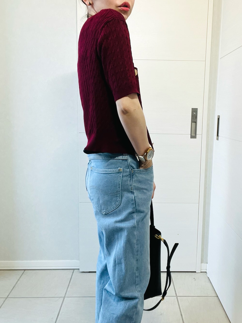 レッド系のカーディガン/ボレロ、ブラック系のバレエシューズ、ブルー系のデニムパンツを着用したレディースの夏コーディネートの3枚目の写真