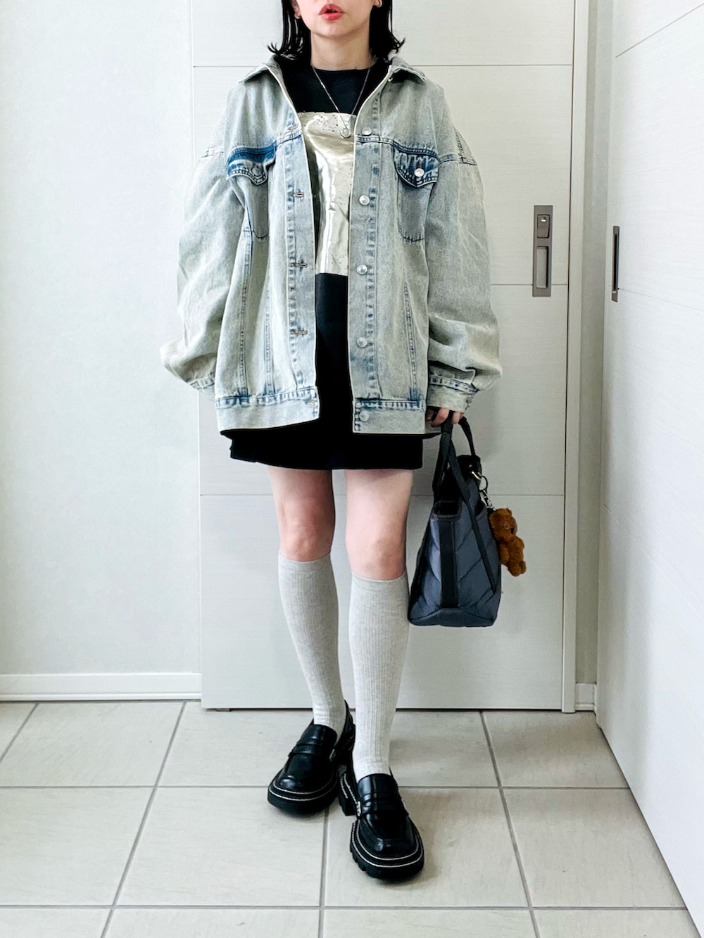 ブルー系のデニムジャケット、ブラック系のスウェット、ブラック系のその他パンツを着用したレディースの冬コーディネートの4枚目の写真