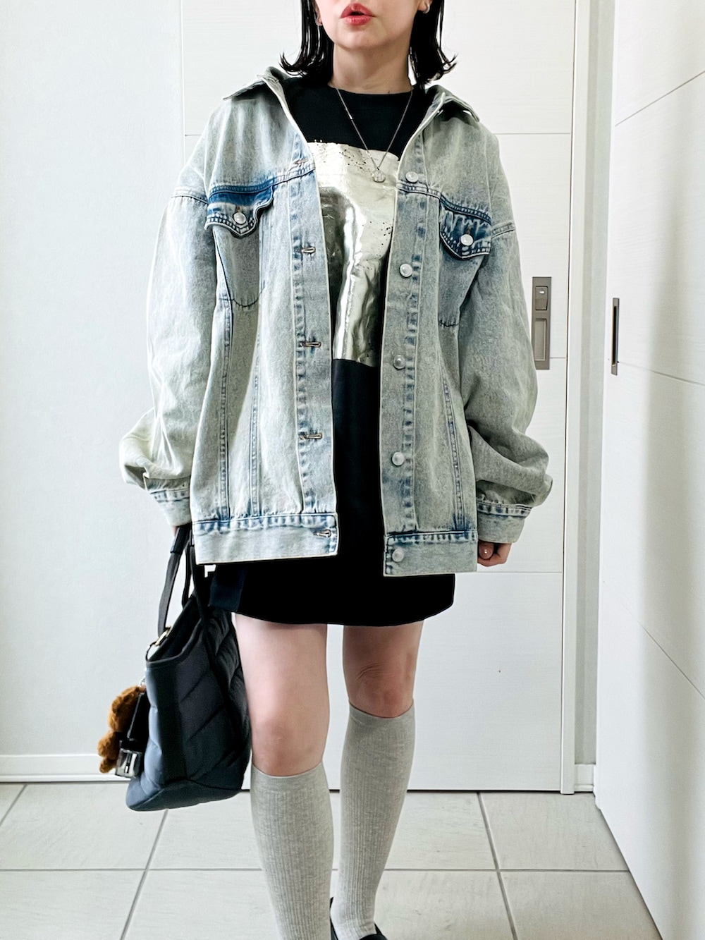 ブルー系のデニムジャケット、ブラック系のスウェット、ブラック系のその他パンツを着用したレディースの冬コーディネートの3枚目の写真