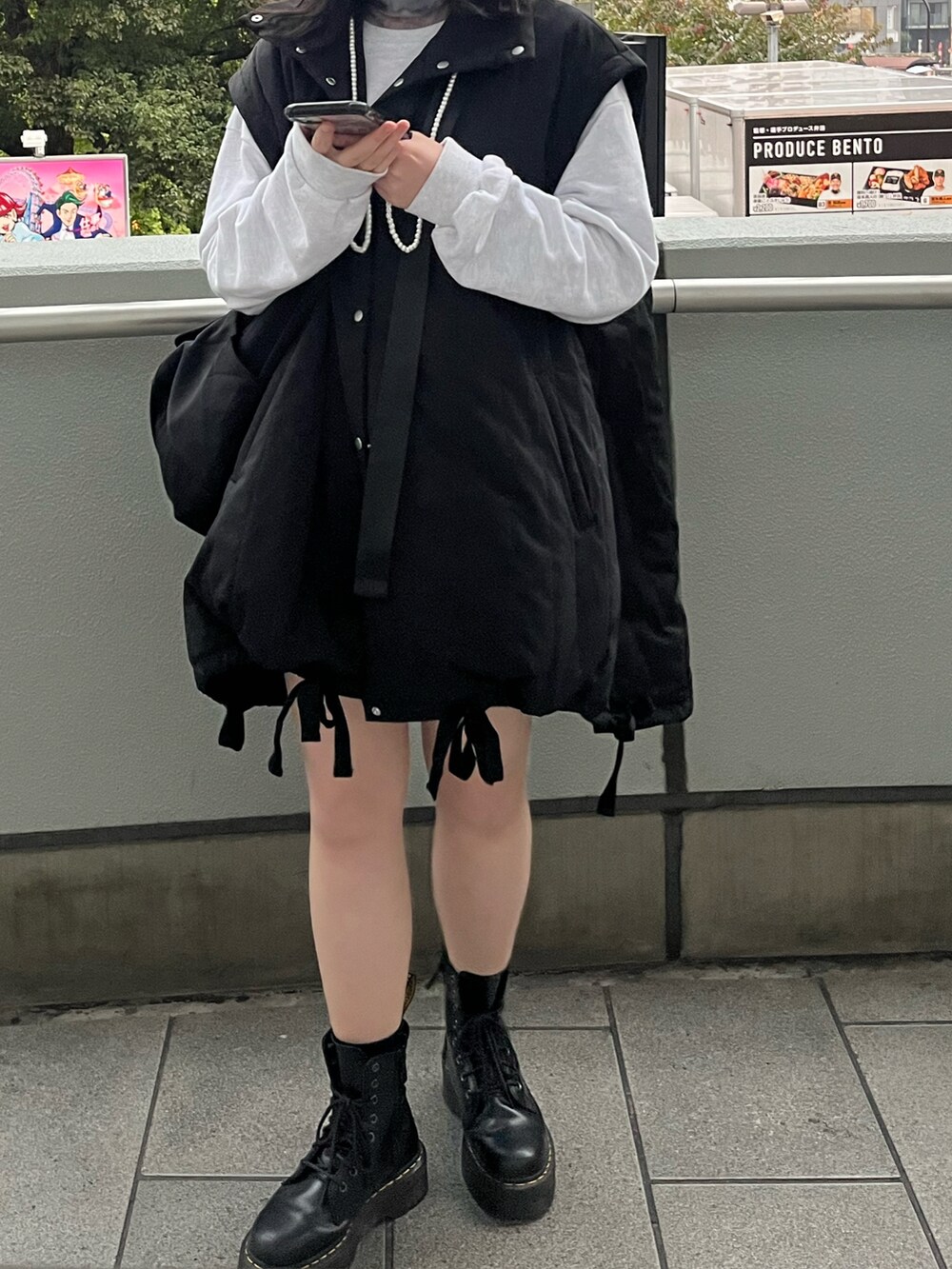 ブラック系のダウンジャケット/コート、ブラック系のブーツ、ブラック系のショルダーバッグを着用したレディースの秋コーディネートの2枚目の写真