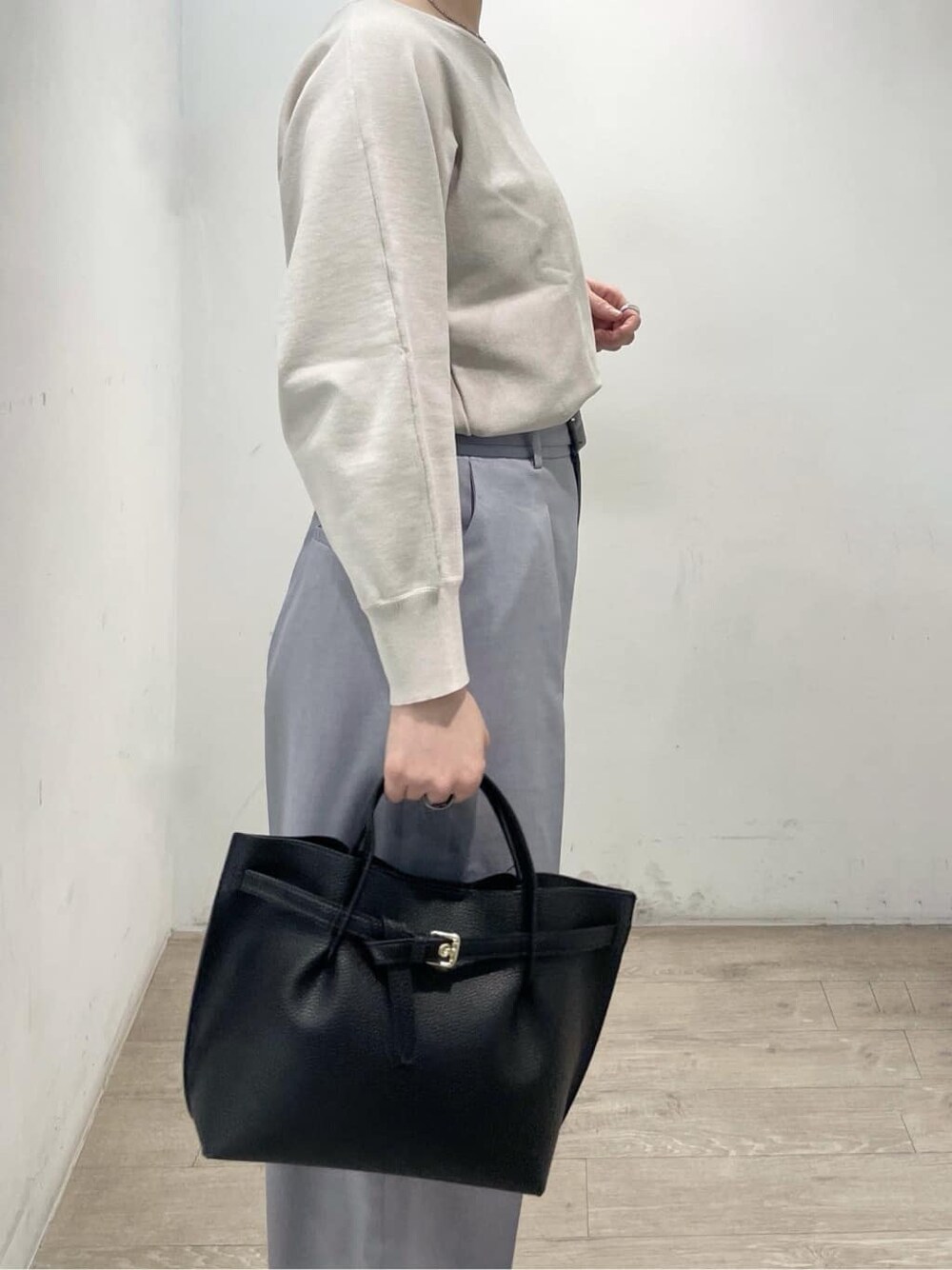 ブラック系のパンプス、グレー系のその他パンツ、ブラック系のトートバッグを着用したレディースの春コーディネートの7枚目の写真
