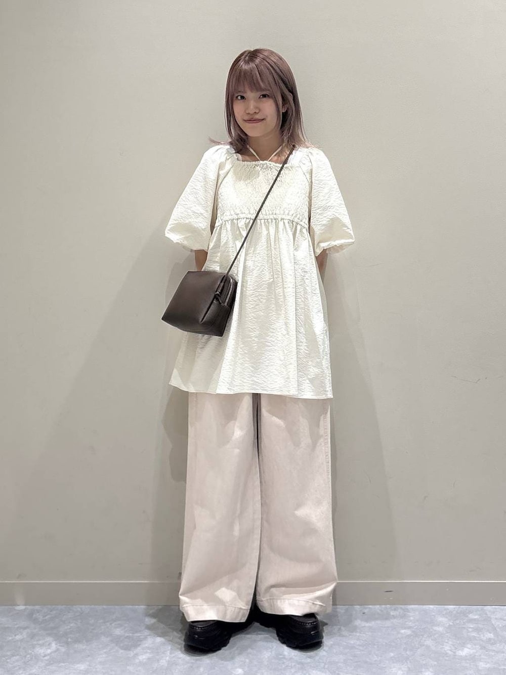 ピンク系のデニムパンツ、ブラウン系のローファー、ブラウン系のトートバッグを着用したレディースの春コーディネートの4枚目の写真