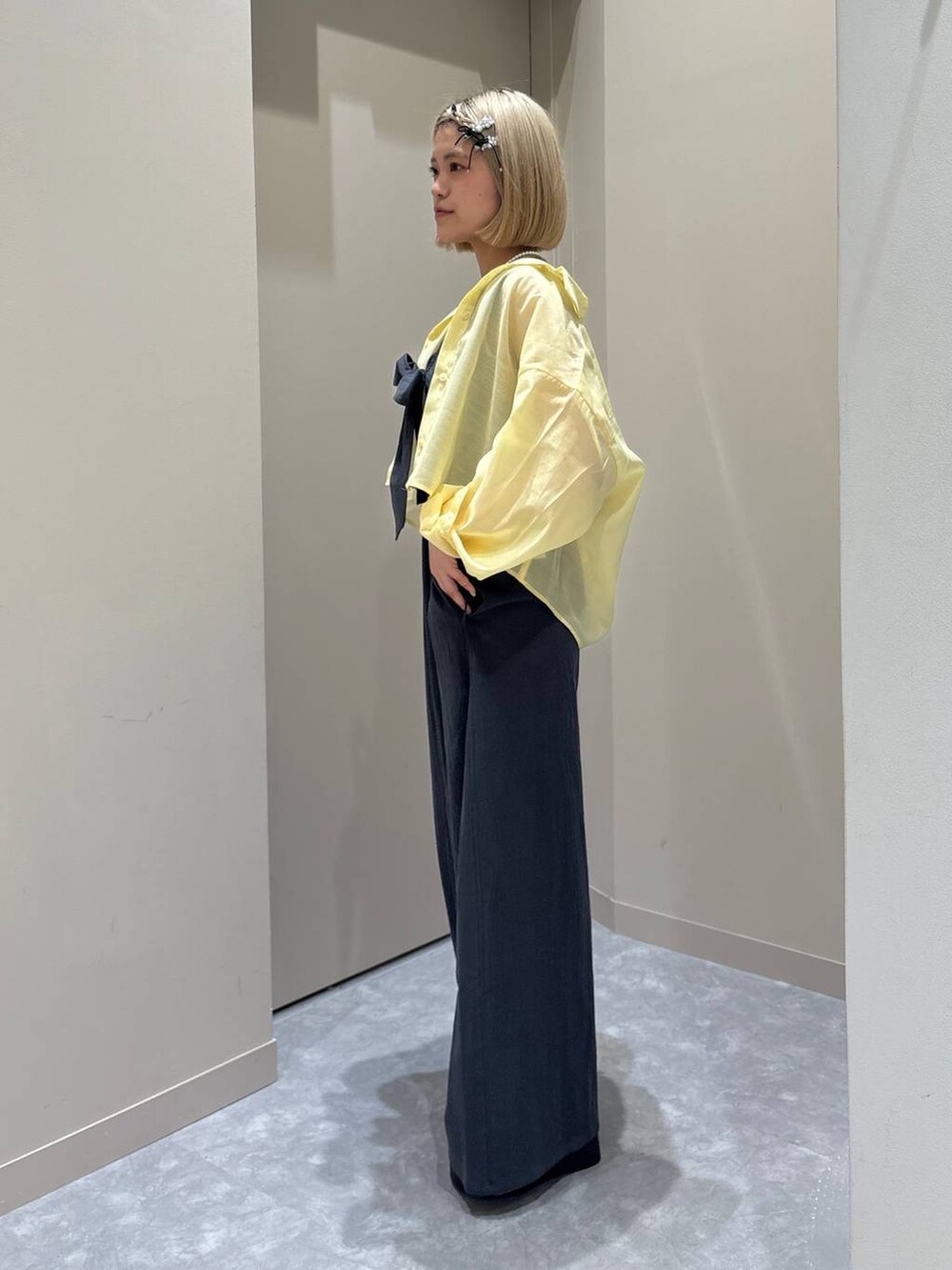 ホワイト系のTシャツ/カットソー、イエロー系のシャツ/ブラウス、ブラック系のサンダルを着用したレディースの春コーディネートの2枚目の写真