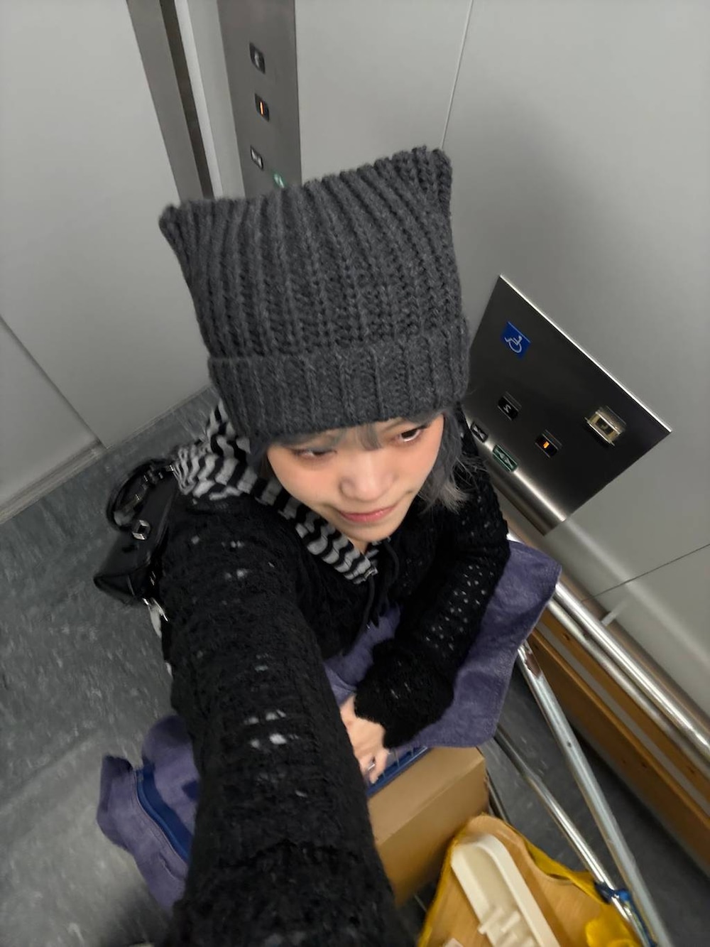 ブラック系のカーディガン/ボレロ、グレー系のニットキャップ/ビーニーを着用したレディースの冬コーディネートの4枚目の写真